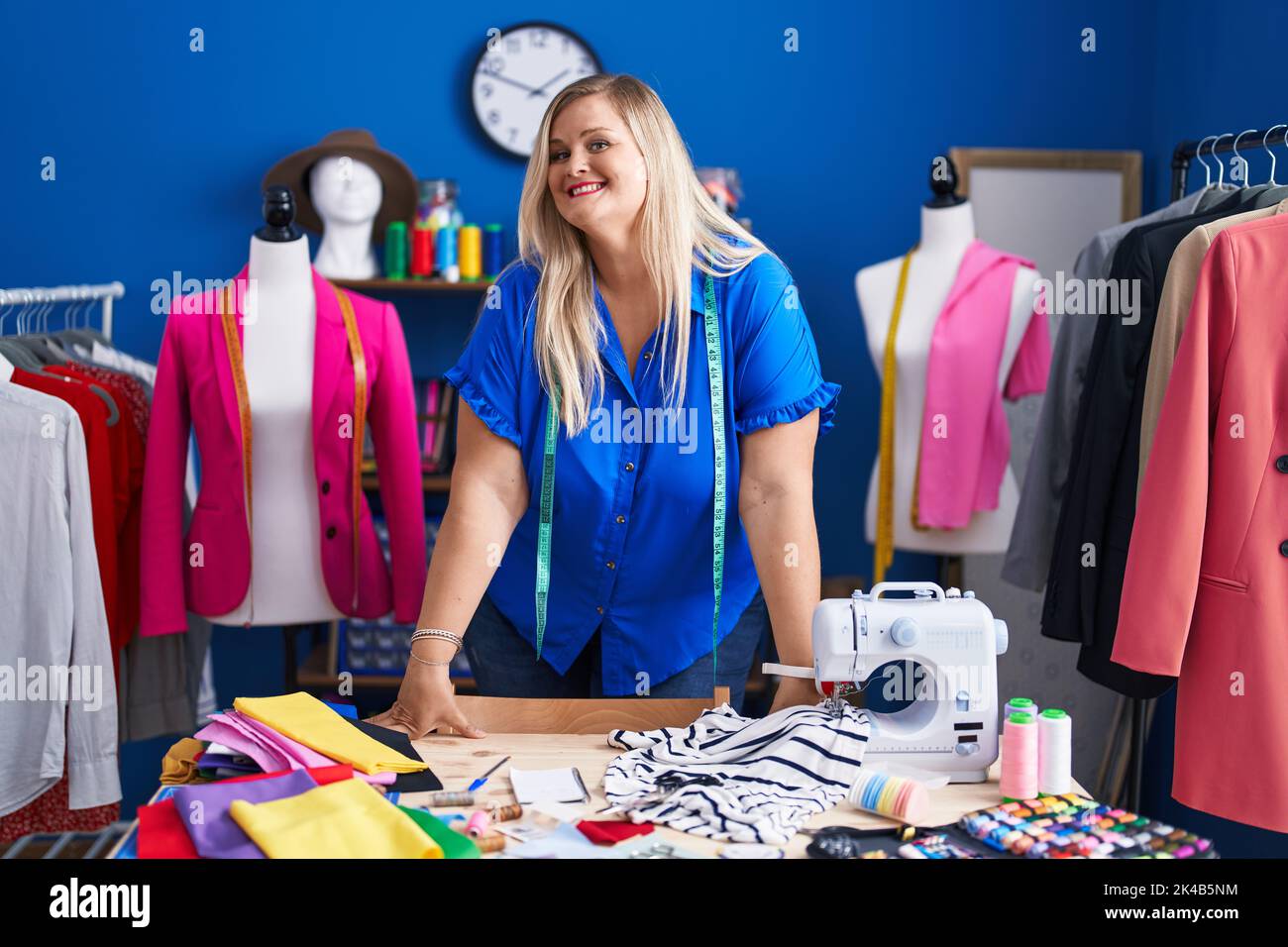Young woman tailor smiling confident standing at sewing studio Stock ...