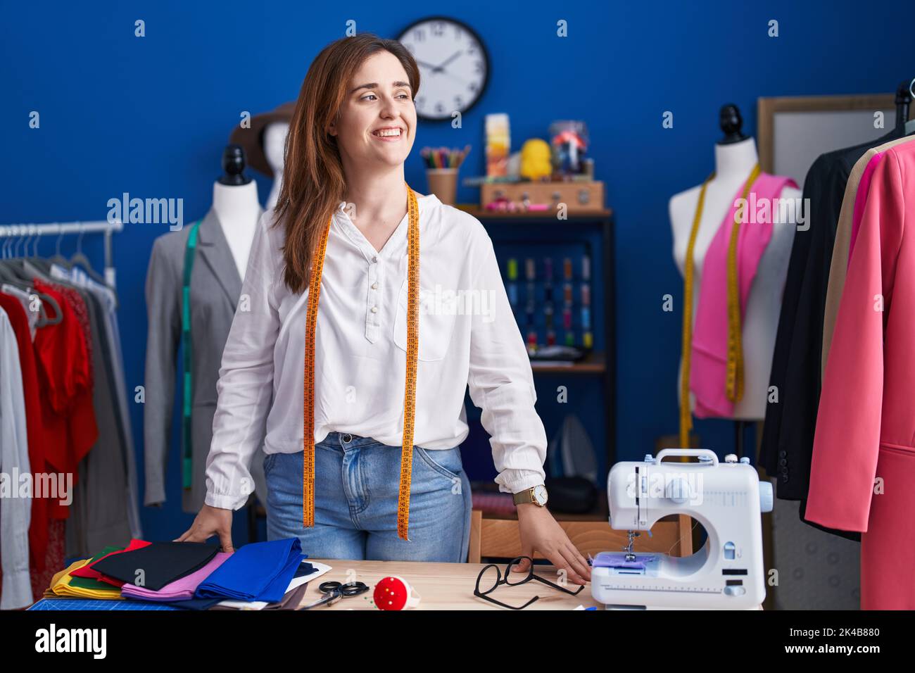 Young woman tailor smiling confident standing at sewing studio Stock ...