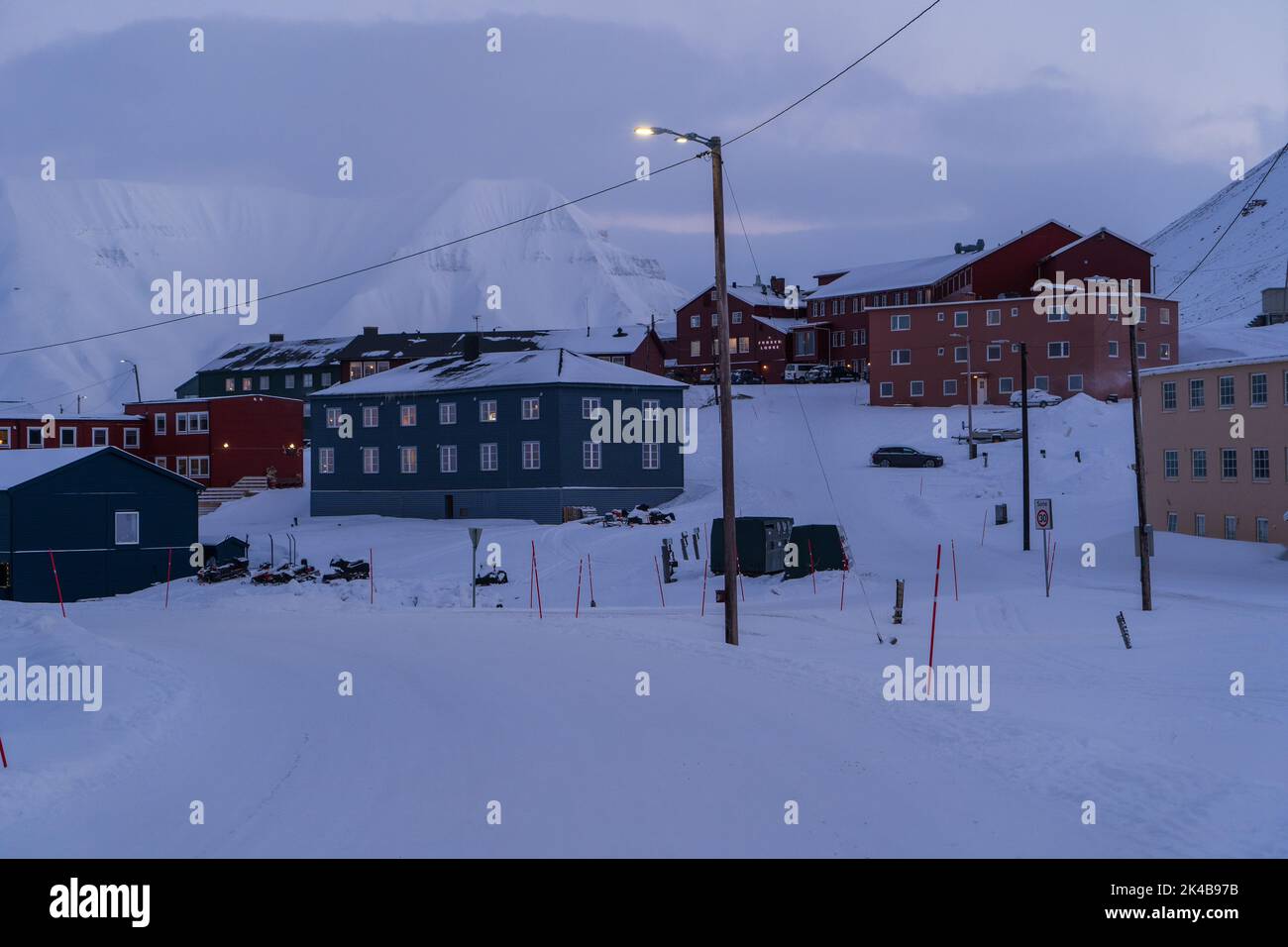 Residential neighbourhood with multi coloured houses in snowy landscape, Longyearbyen, Svalbard Stock Photo