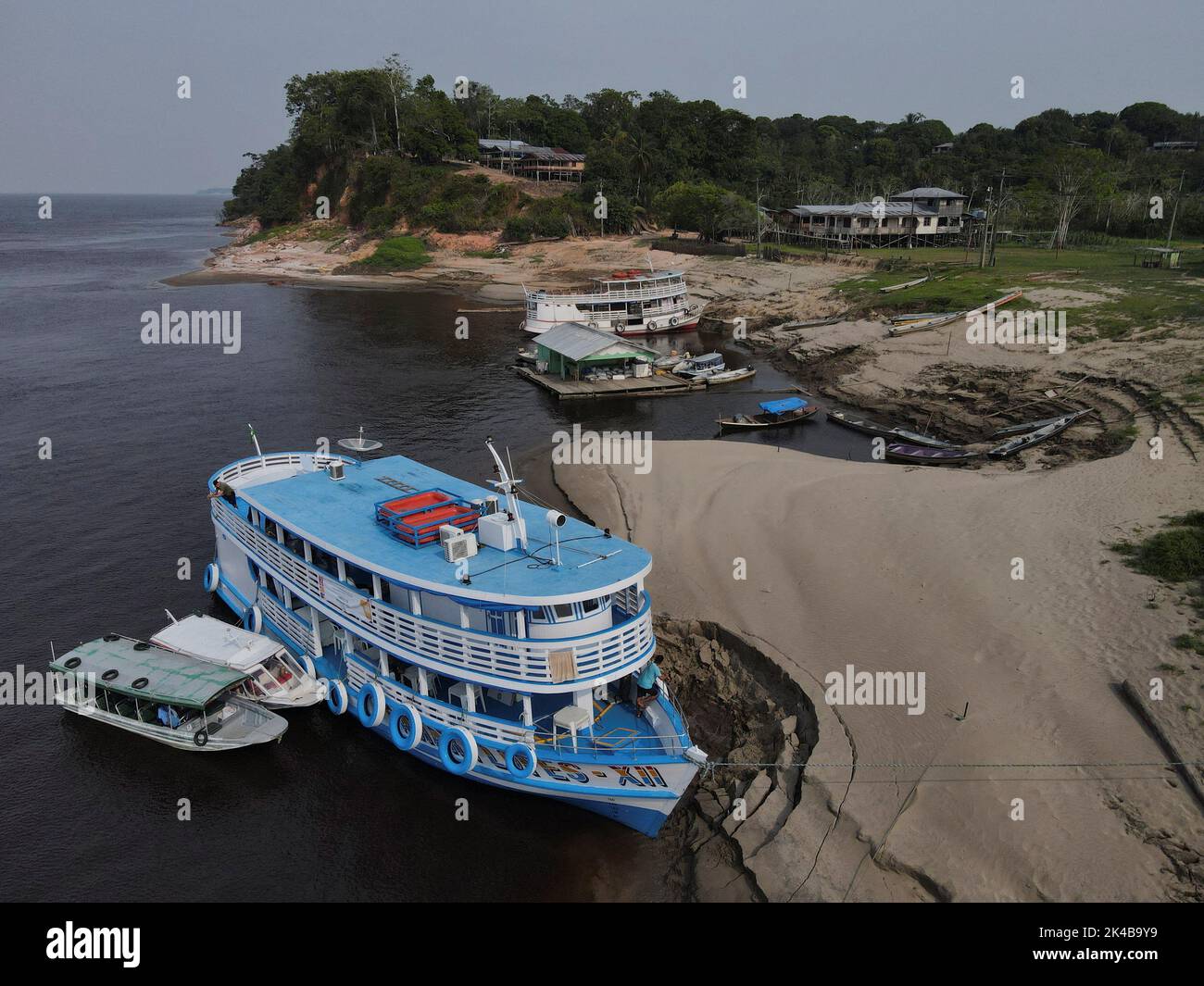 A views shows boats on the banks of Amazonas River while electronic ballot boxes are transported to voting stations to a community of 'ribeirinhos' (forest dwellers) ahead of Brazilian elections, in Manaus, Brazil October 1, 2022. REUTERS/Bruno Kelly Stock Photo
