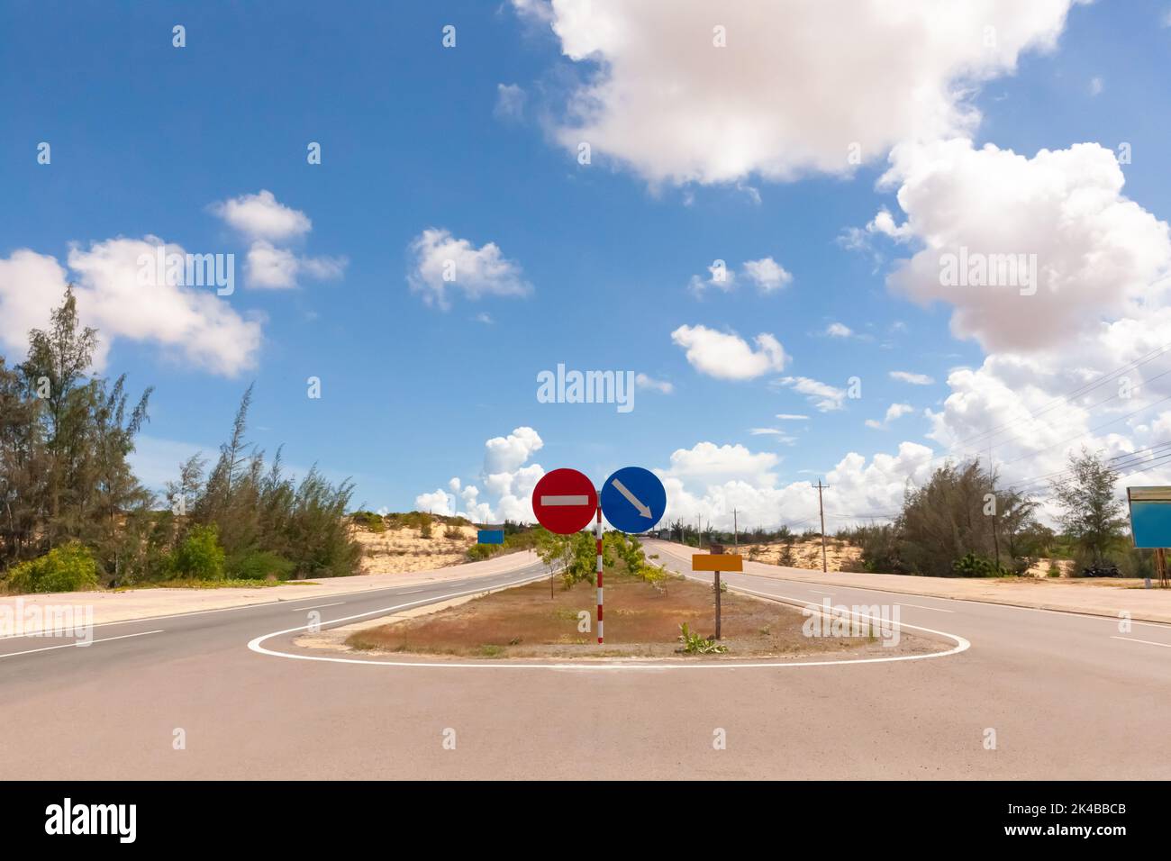 Coastal road with road sign in Phan Thiet, Mui Ne, Viet Nam. beautiful landsacpe with blue sky and white cloud in summer day Stock Photo