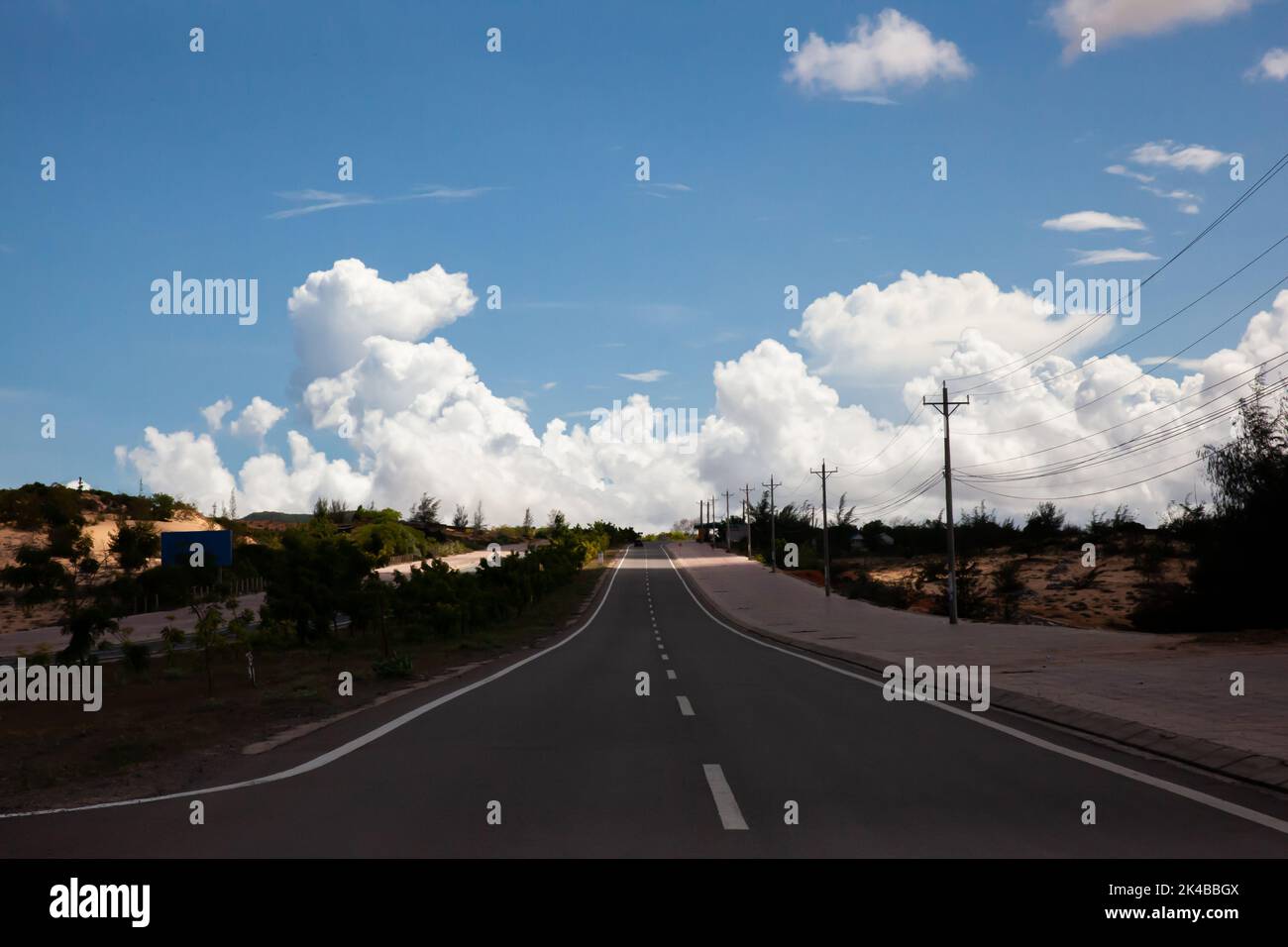 Coastal road in Phan Thiet, Mui Ne, Viet Nam. beautiful landsacpe with blue sky and white cloud in summer day Stock Photo