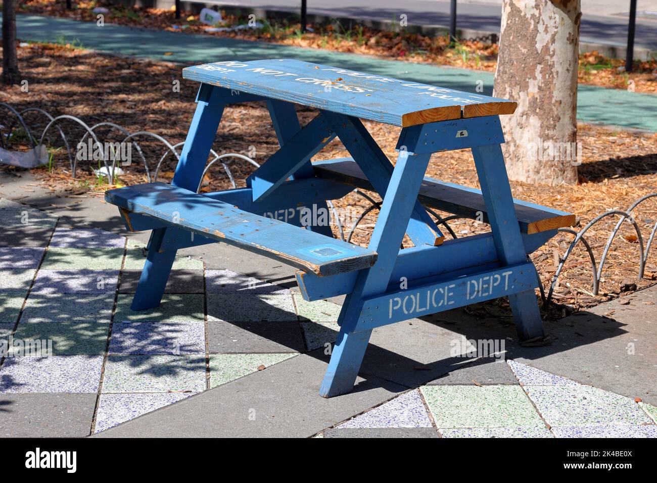 A NYPD police barricade upcycled for use as a picnic table; a functional piece of furniture and art piece left at a park in Manhattan, New York Stock Photo