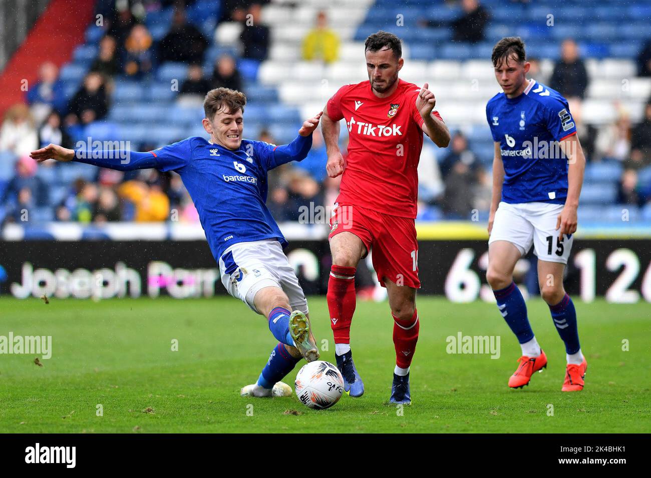 Oldham, UK. 1st October 2022during the Vanarama National League match between Oldham Athletic and Wrexham at Boundary Park, Oldham on Saturday 1st October 2022Ben Tollitt of Oldham Athletic tussles with Anthony Forde of Wrexham Football Club during the Vanarama National League match between Oldham Athletic and Wrexham at Boundary Park, Oldham on Saturday 1st October 2022during the Vanarama National League match between Oldham Athletic and Wrexham at Boundary Park, Oldham on Saturday 1st October 2022. Credit: MI News & Sport /Alamy Live News Stock Photo