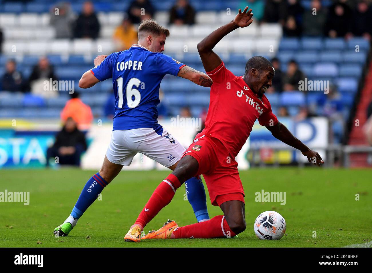 Oldham, UK. 1st October 2022during the Vanarama National League match between Oldham Athletic and Wrexham at Boundary Park, Oldham on Saturday 1st October 2022Charlie Cooper of Oldham Athletic tussles with Aaron Hayden of Wrexham Football Club during the Vanarama National League match between Oldham Athletic and Wrexham at Boundary Park, Oldham on Saturday 1st October 2022during the Vanarama National League match between Oldham Athletic and Wrexham at Boundary Park, Oldham on Saturday 1st October 2022. Credit: MI News & Sport /Alamy Live News Stock Photo