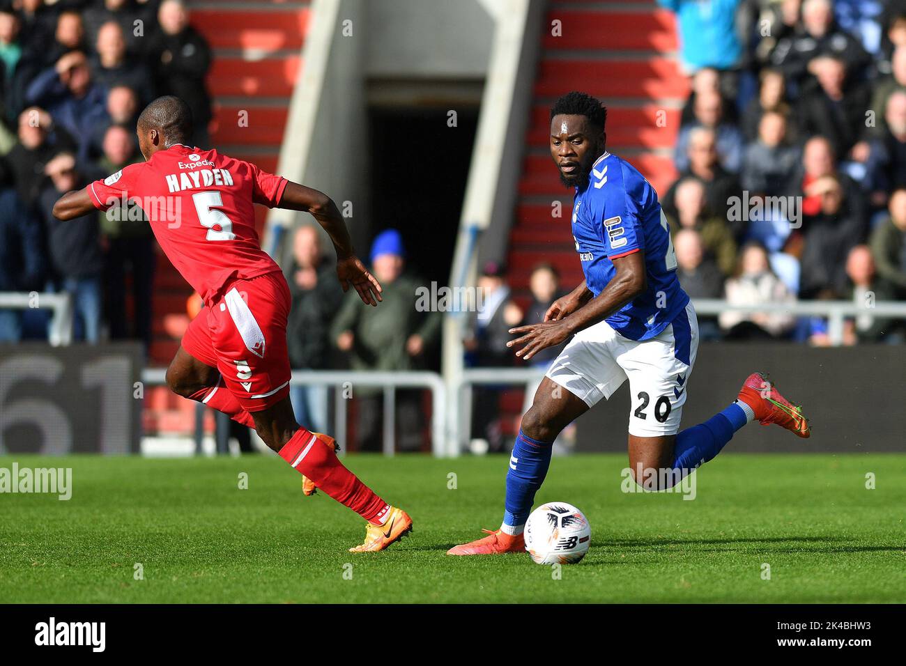 Oldham, UK. 1st October 2022during the Vanarama National League match between Oldham Athletic and Wrexham at Boundary Park, Oldham on Saturday 1st October 2022Mike Fondop-Talom of Oldham Athletic tussles with Aaron Hayden of Wrexham Football Club during the Vanarama National League match between Oldham Athletic and Wrexham at Boundary Park, Oldham on Saturday 1st October 2022. Credit: MI News & Sport /Alamy Live News Stock Photo