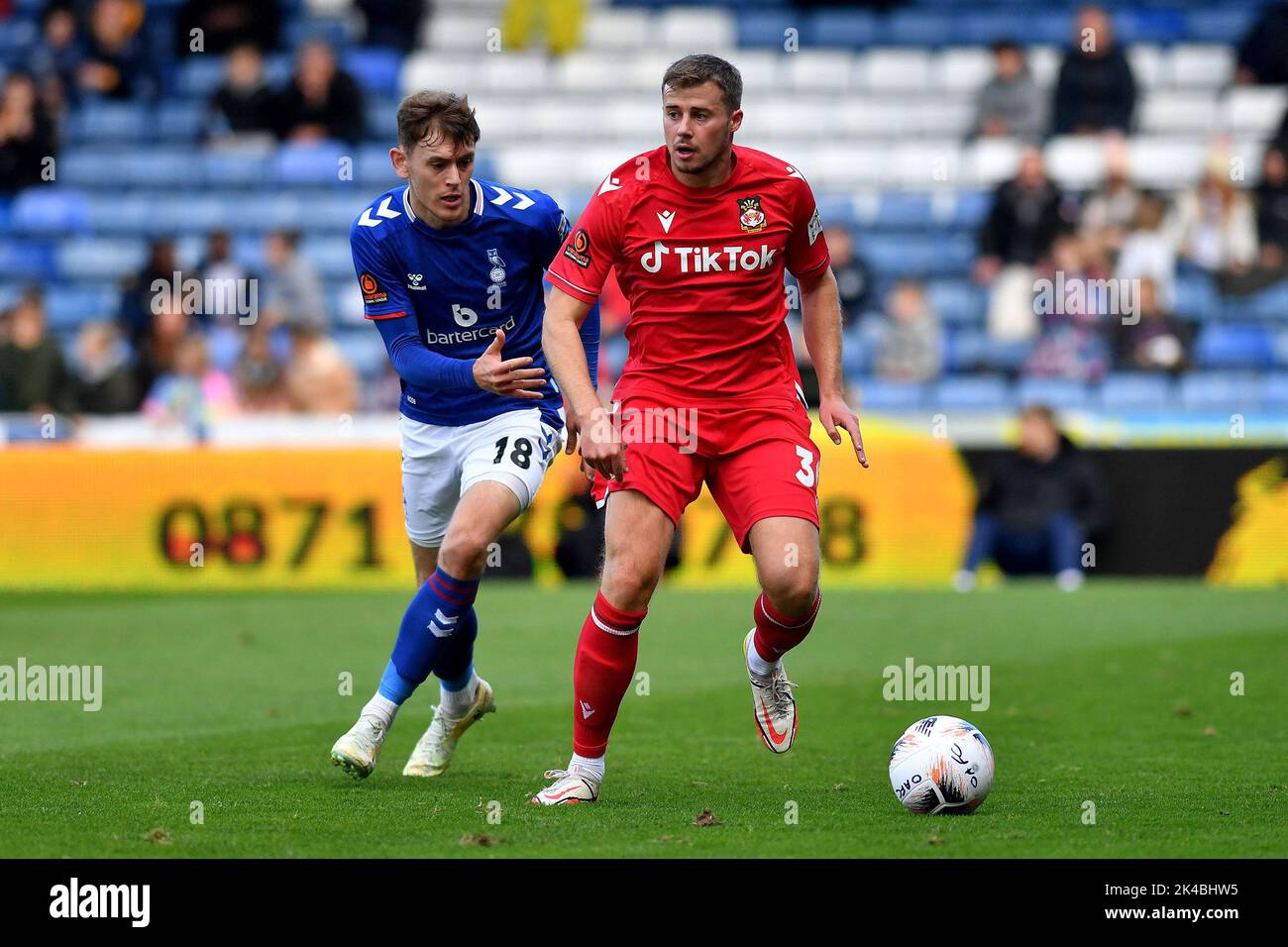 Oldham, UK. 1st October 2022during the Vanarama National League match between Oldham Athletic and Wrexham at Boundary Park, Oldham on Saturday 1st October 2022Ben Tollitt of Oldham Athletic tussles with James Jones of Wrexham Football Club during the Vanarama National League match between Oldham Athletic and Wrexham at Boundary Park, Oldham on Saturday 1st October 2022. Credit: MI News & Sport /Alamy Live News Stock Photo