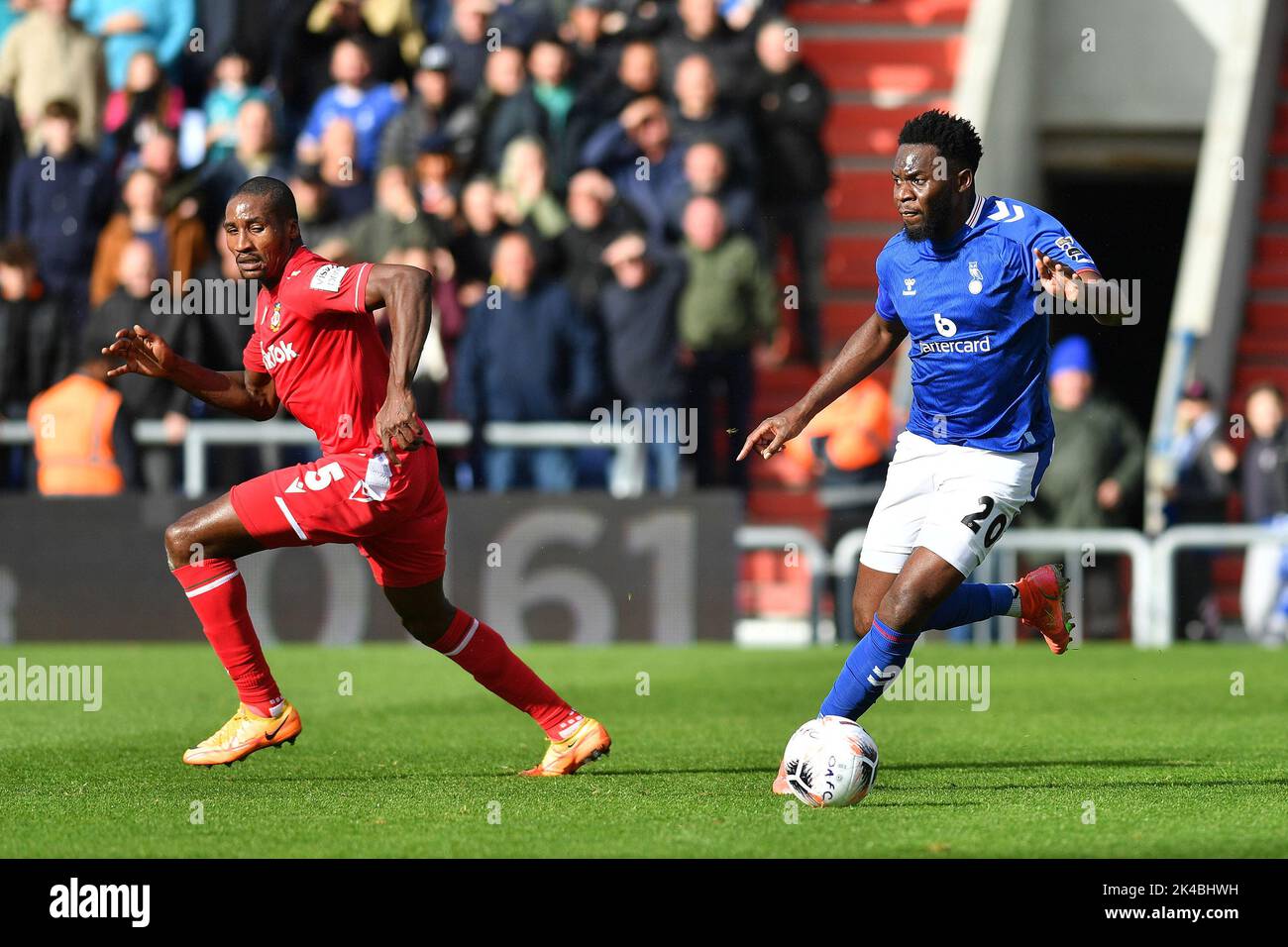 Oldham, UK. 1st October 2022during the Vanarama National League match between Oldham Athletic and Wrexham at Boundary Park, Oldham on Saturday 1st October 2022Mike Fondop-Talom of Oldham Athletic tussles with Aaron Hayden of Wrexham Football Club during the Vanarama National League match between Oldham Athletic and Wrexham at Boundary Park, Oldham on Saturday 1st October 2022. Credit: MI News & Sport /Alamy Live News Stock Photo