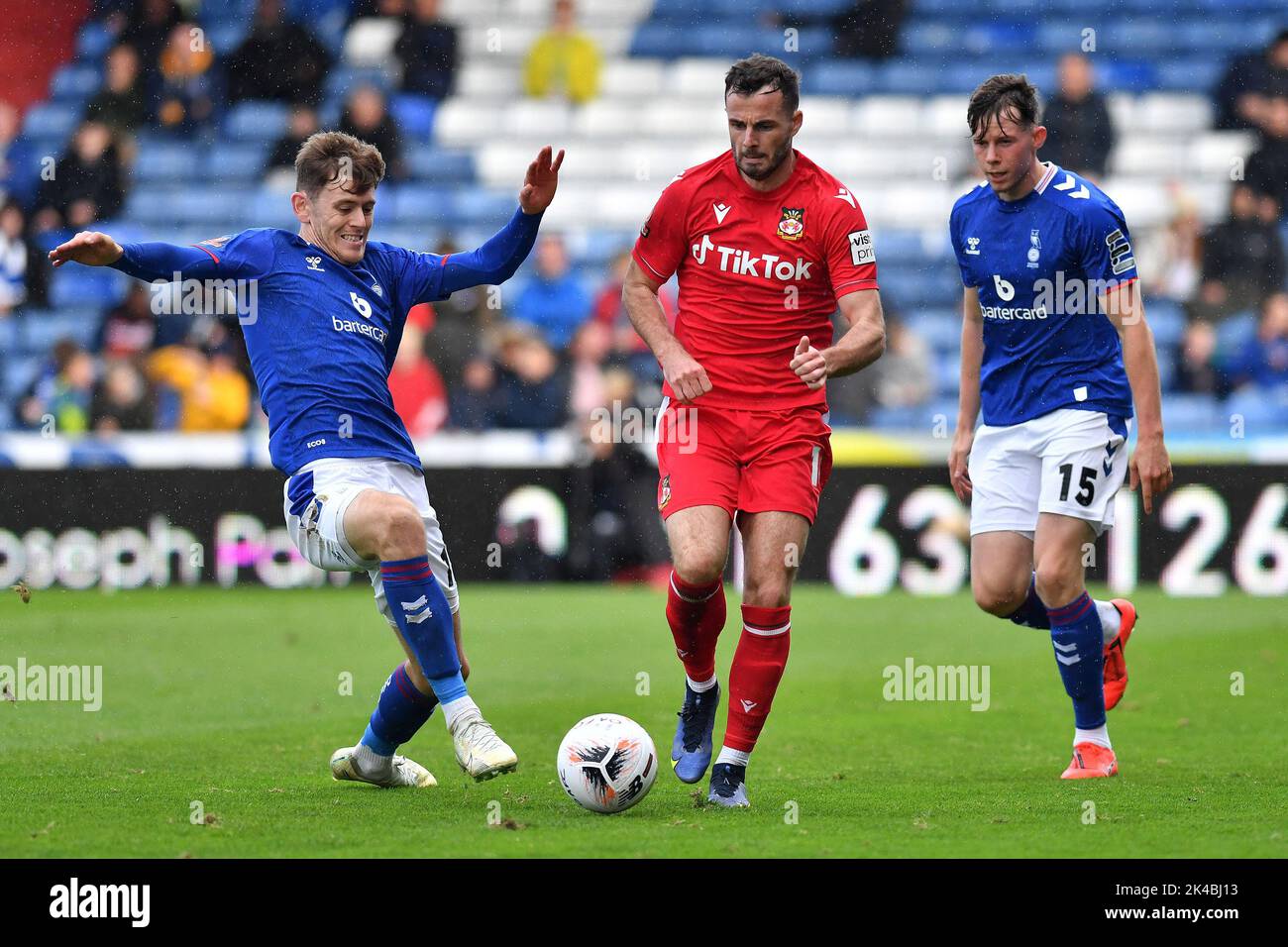 Oldham, UK. 1st October 2022during the Vanarama National League match between Oldham Athletic and Wrexham at Boundary Park, Oldham on Saturday 1st October 2022. (Credit: Eddie Garvey | eg13photography)Ben Tollitt of Oldham Athletic and Mitchell Roberts of Oldham Athletic tussles with Anthony Forde of Wrexham Football Club during the Vanarama National League match between Oldham Athletic and Wrexham at Boundary Park, Oldham on Saturday 1st October 2022. Credit: MI News & Sport /Alamy Live News Stock Photo