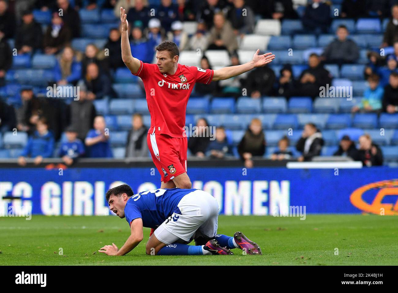 Oldham, UK. 1st October 2022during the Vanarama National League match between Oldham Athletic and Wrexham at Boundary Park, Oldham on Saturday 1st October 2022. (Credit: Eddie Garvey | eg13photography)James Carragher of Oldham Athletic tussles with Paul Mullin of Wrexham Football Club during the Vanarama National League match between Oldham Athletic and Wrexham at Boundary Park, Oldham on Saturday 1st October 2022. (Credit: Eddie Garvey | eg13photography)during the Vanarama National League match between Oldham Athletic and Wrexham at Boundary Park, Oldham on Saturday 1st October 2022. Credit: Stock Photo