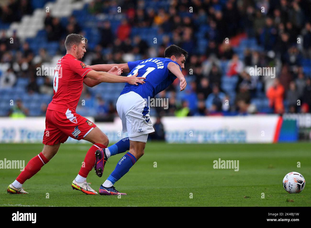 Oldham, UK. 1st October 2022during the Vanarama National League match between Oldham Athletic and Wrexham at Boundary Park, Oldham on Saturday 1st October 2022. (Credit: Eddie Garvey | eg13photography)James Carragher of Oldham Athletic tussles with James Jones of Wrexham Football Club during the Vanarama National League match between Oldham Athletic and Wrexham at Boundary Park, Oldham on Saturday 1st October 2022. (Credit: Eddie Garvey | eg13photography)during the Vanarama National League match between Oldham Athletic and Wrexham at Boundary Park, Oldham on Saturday 1st October 2022. Credit:  Stock Photo