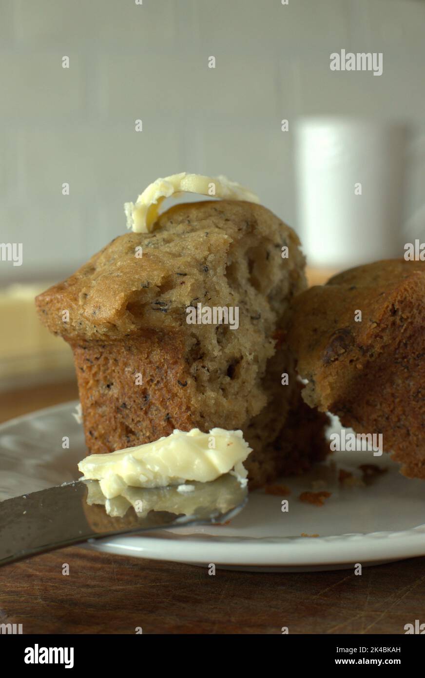 Banana muffins with butter on wooden table for breakfast. Stock Photo