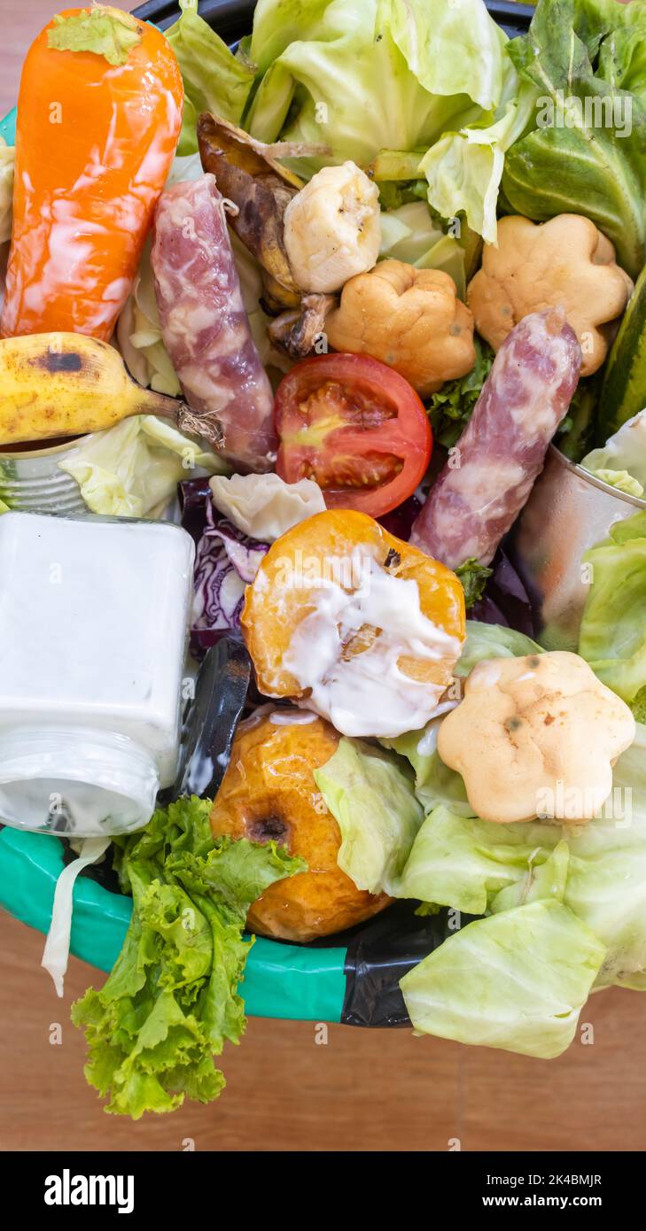 Waste bin with unused food. Food waste as a global problem in the world. Interior. Closeup