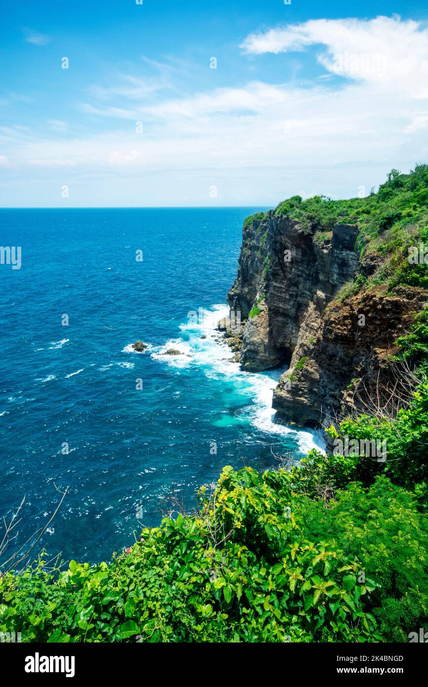A vertical shot of the beach waves and rocks Stock Photo - Alamy