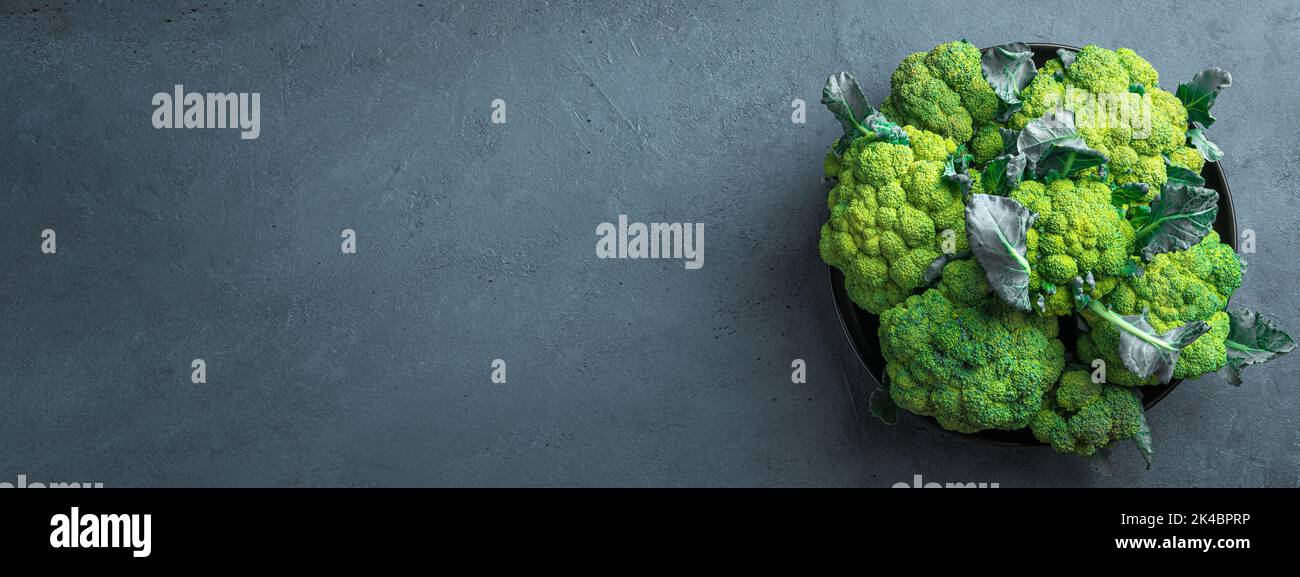 Broccoli in a black plate on a graphite background. Stock Photo