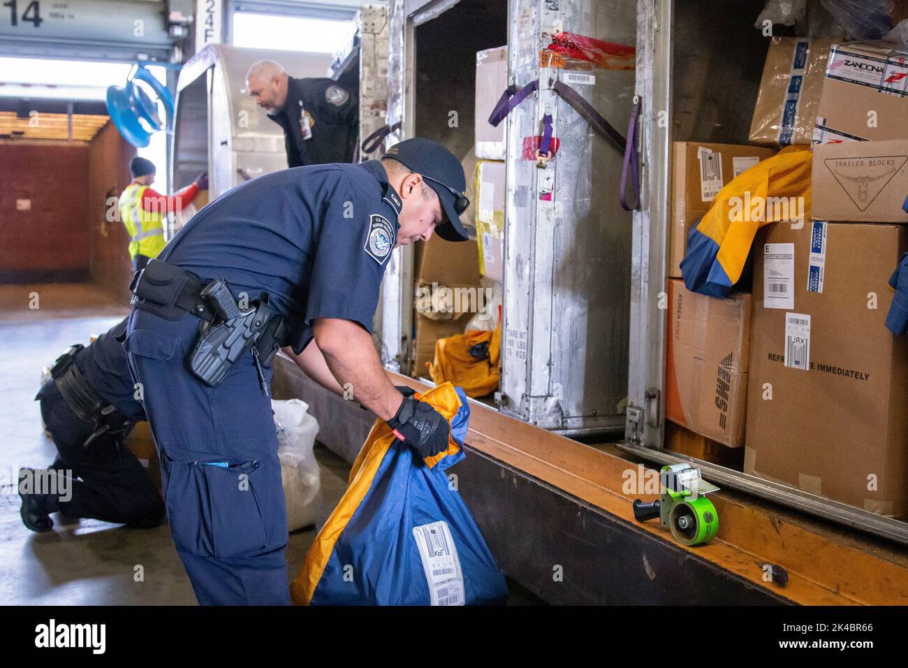 Customs and Border Protection officers assigned to the Area Port of Jacksonville, Florida perform consignment inspections of foreign packages arriving to the United States on Feb. 20. Photo by Ozzy Trevino, U.S. Customs and Border Protection Stock Photo