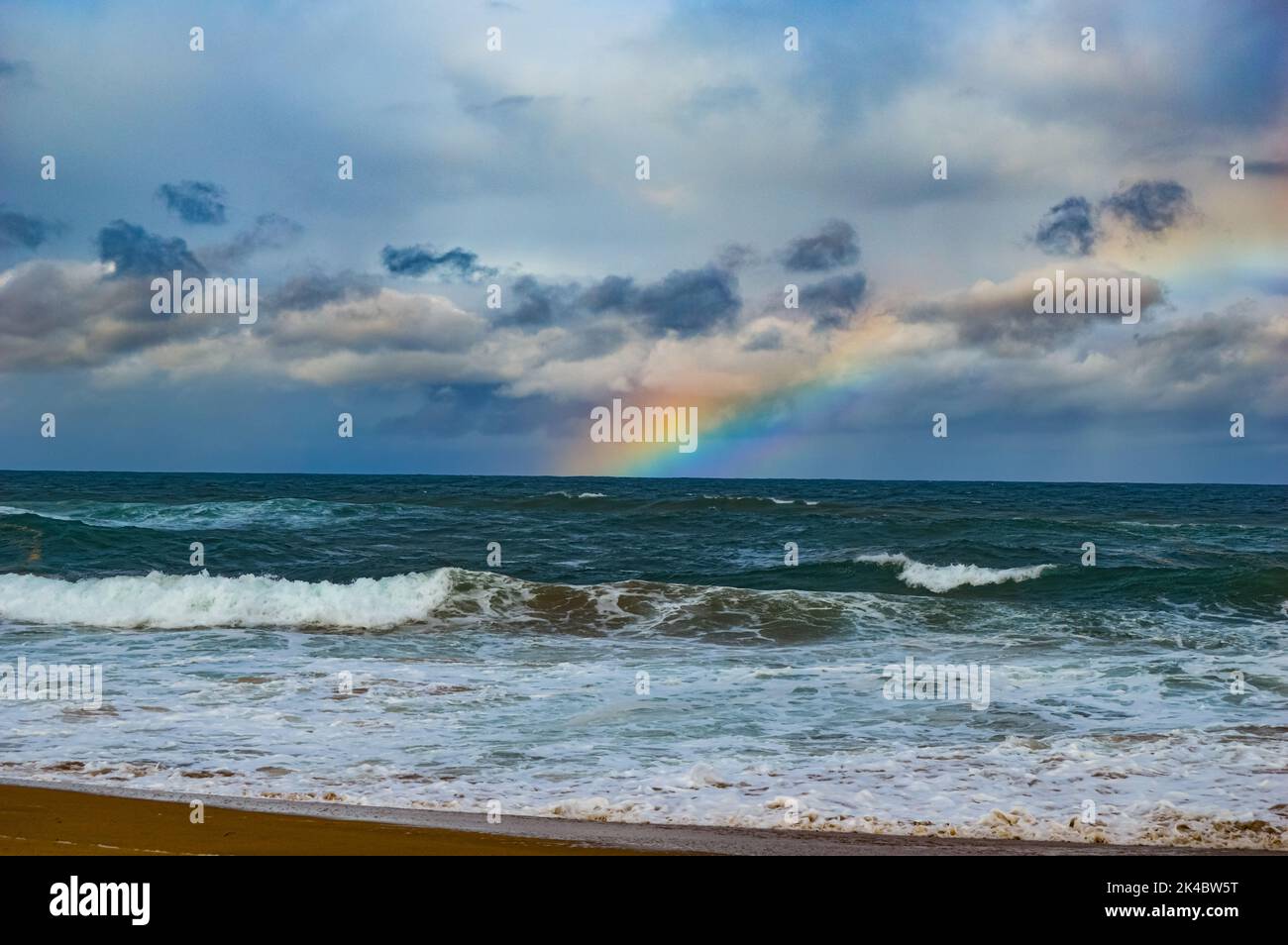 The beautiful rainbow over the ocean Stock Photo - Alamy