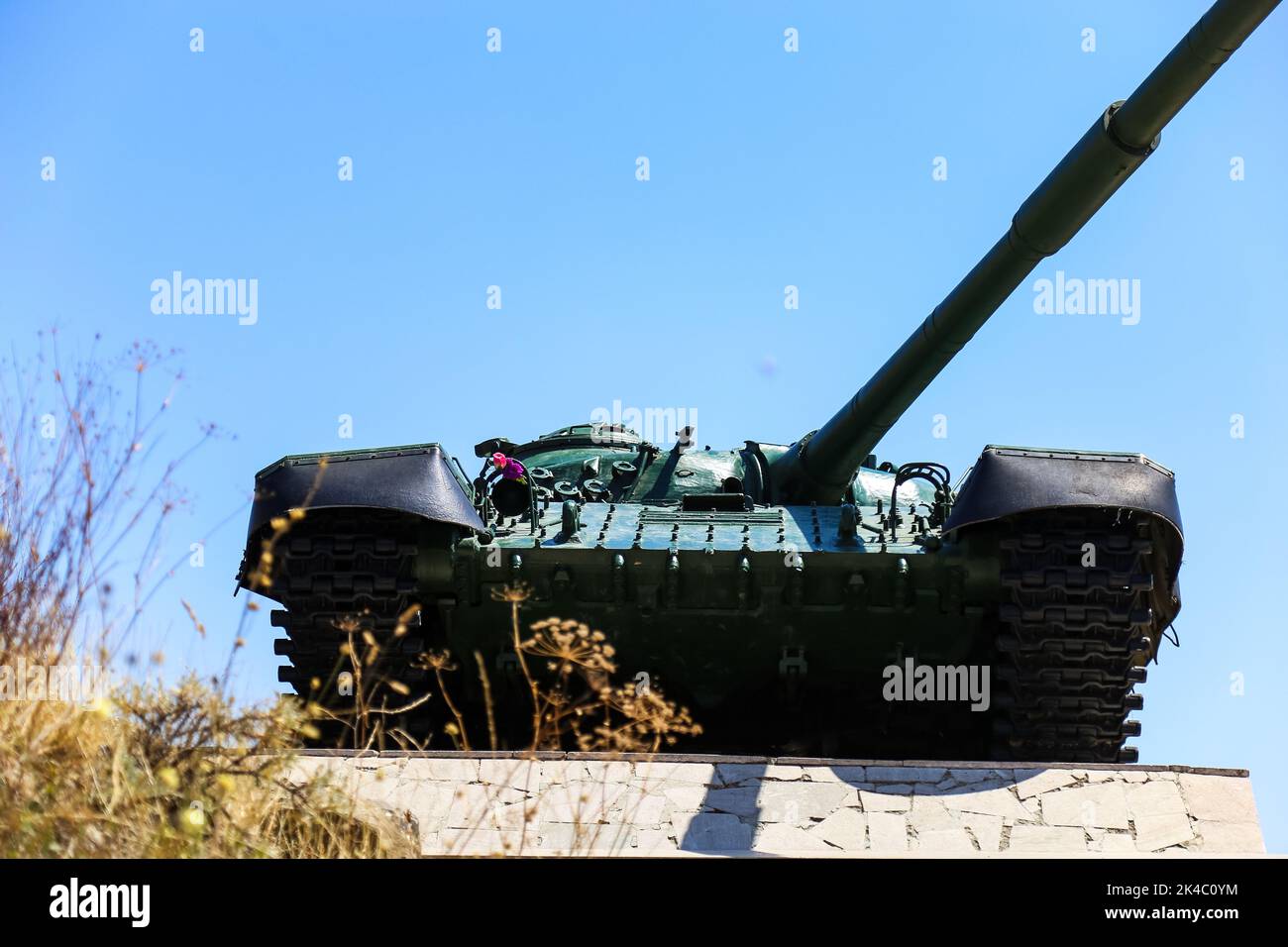 An old tank against the cloudless sky Stock Photo