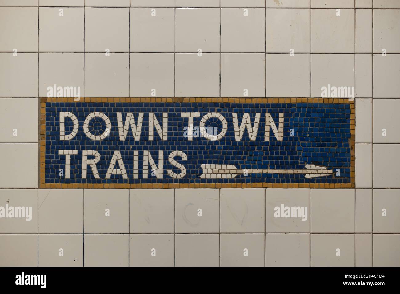Tiled New York City subway train sign with arrow pointing direction. Stock Photo