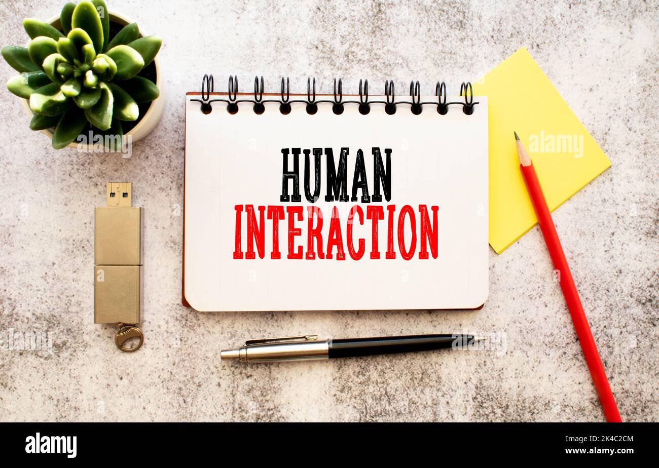 text HUMAN INTERACTION on white paper Stock Photo