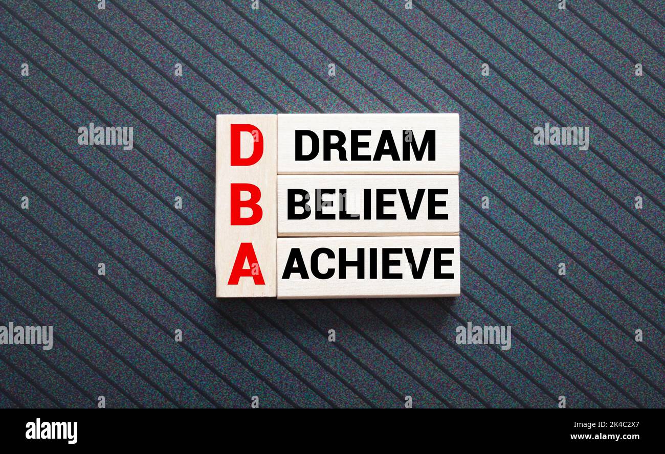 Believe Achieve Succeed text with wooden blocks in the shape of a ...