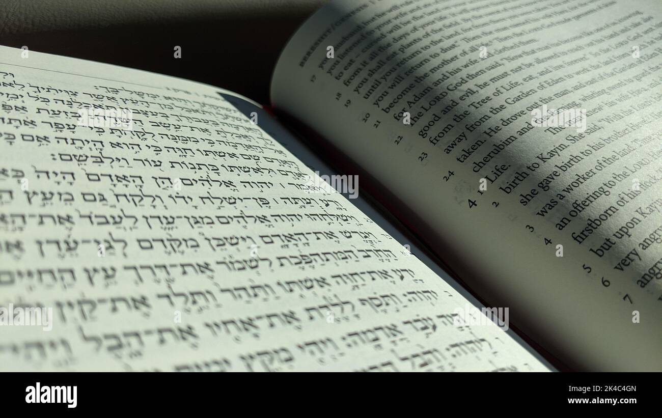 Open Bible with Hebrew and English Texts Side by Side Stock Photo