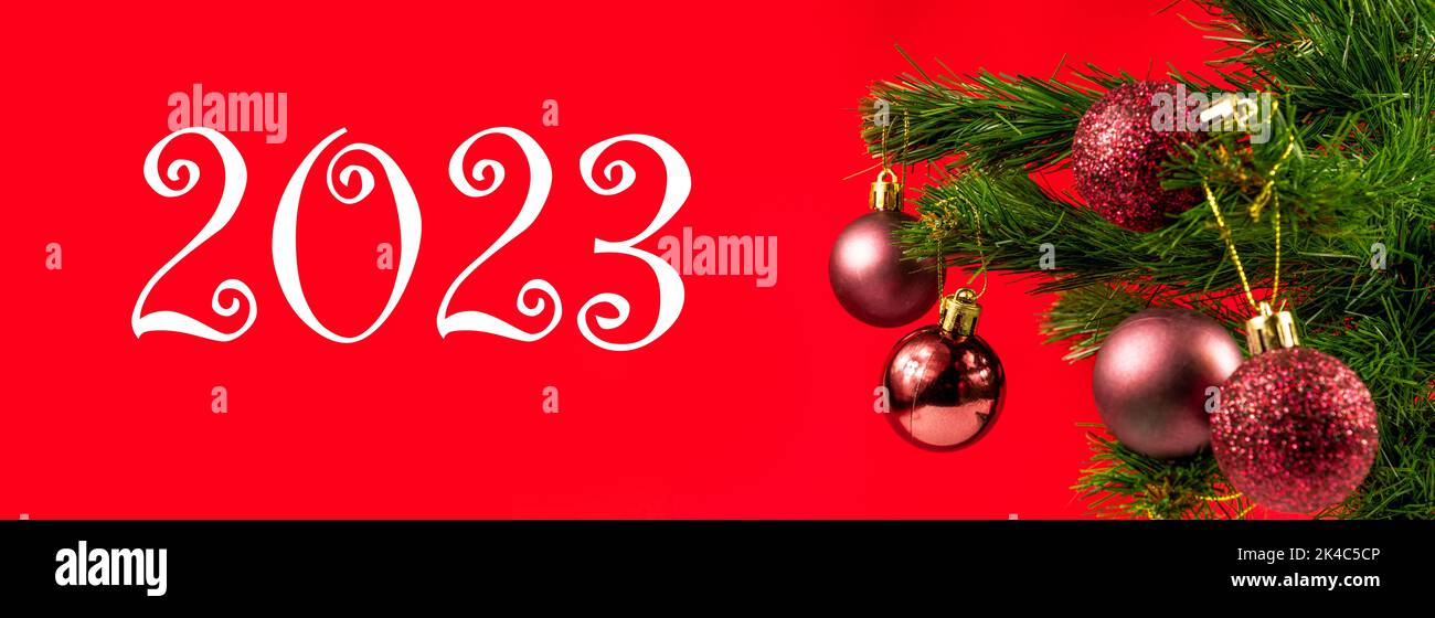 Christmas banner concept idea. Christmas tree with shiny ornaments and merry christmas, 2023, happy new year background or wallpaper Stock Photo