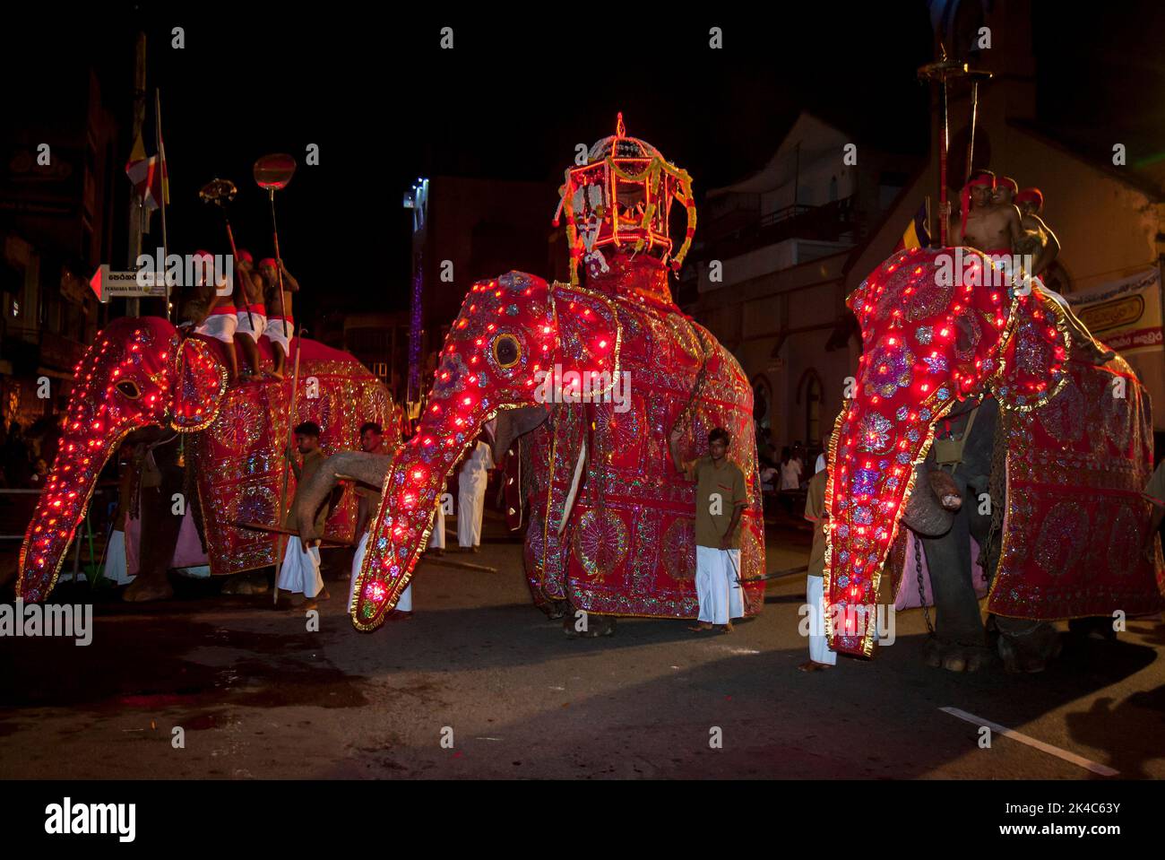 KANDY, SRI LANKA - AUGUST 25, 2015 : A trio of ceremonlal elephants parade through the streets of Kandy in Sri Lanka during the Buddhist Esala Peraher Stock Photo