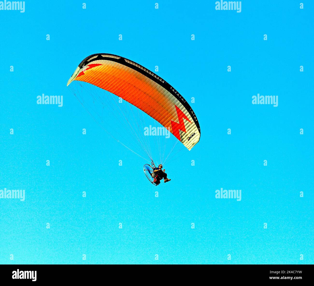 Hang Glider, Parachute, plain blue sky, Norfolk, England Stock Photo