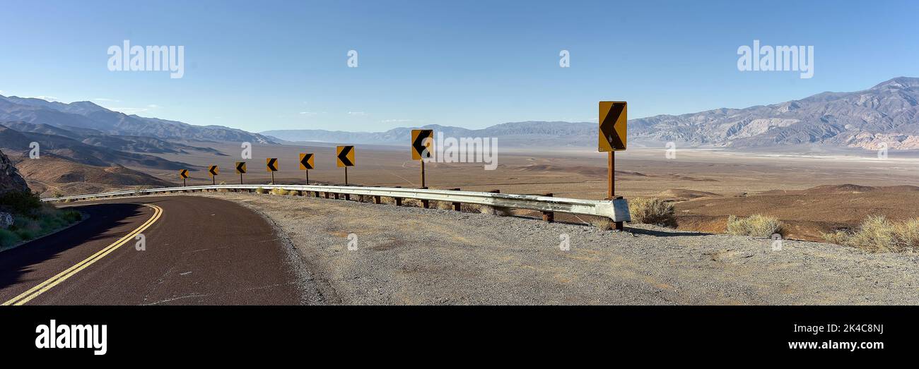 The view of left turn on Trona Wildrose Road before the mountains landscape under the blue sky Stock Photo