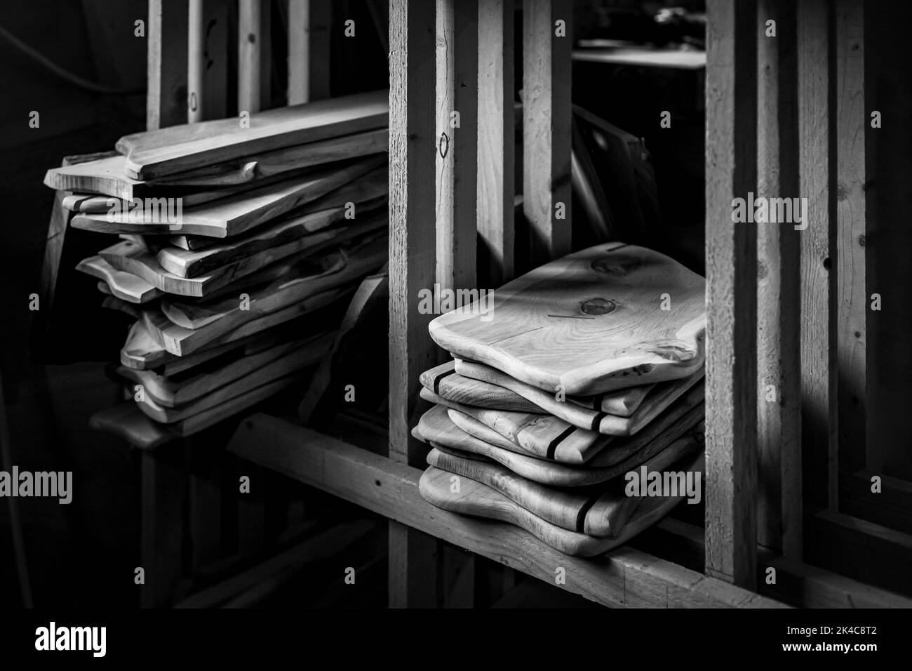 A greyscale shot of small wooden boards in a workshop Stock Photo