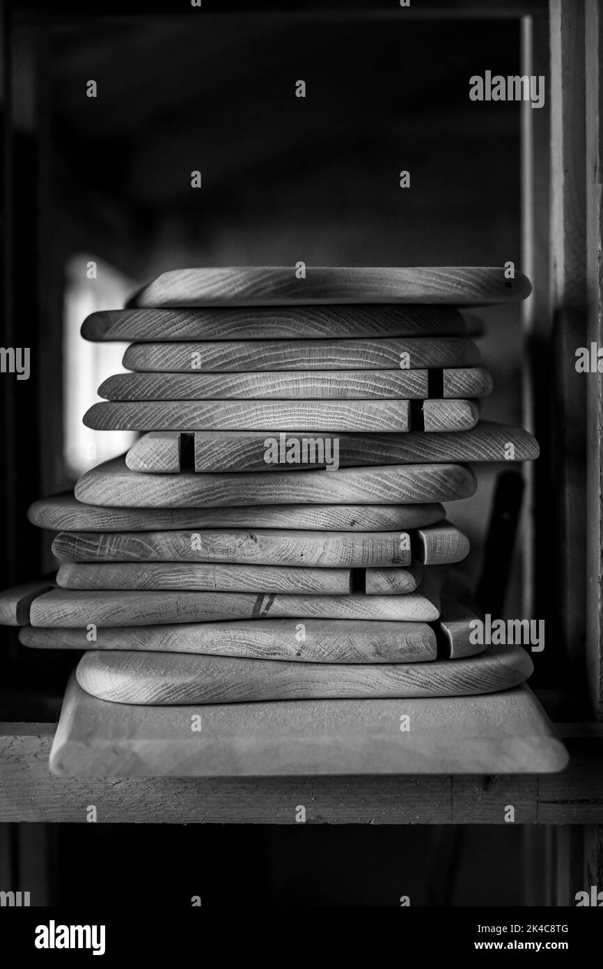 A greyscale shot of small wooden boards in a workshop Stock Photo