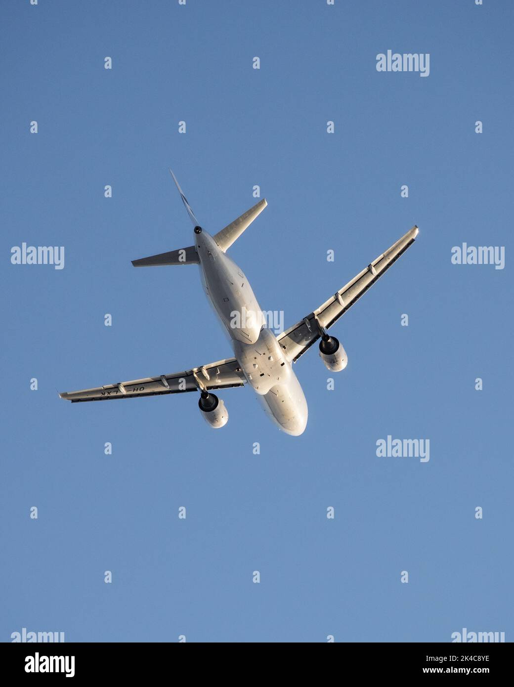 A low angle shot of white Finnair airplane in the blue sky Stock Photo