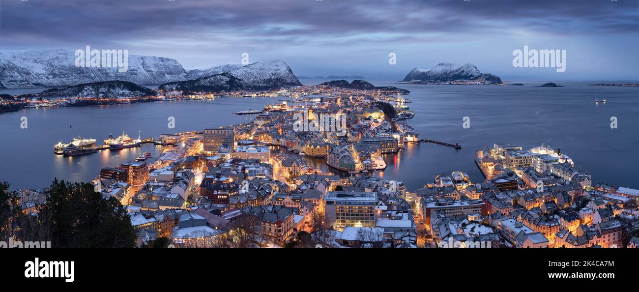 Evening panorama of the snowy city of Alesund in illumination in Norway Stock Photo