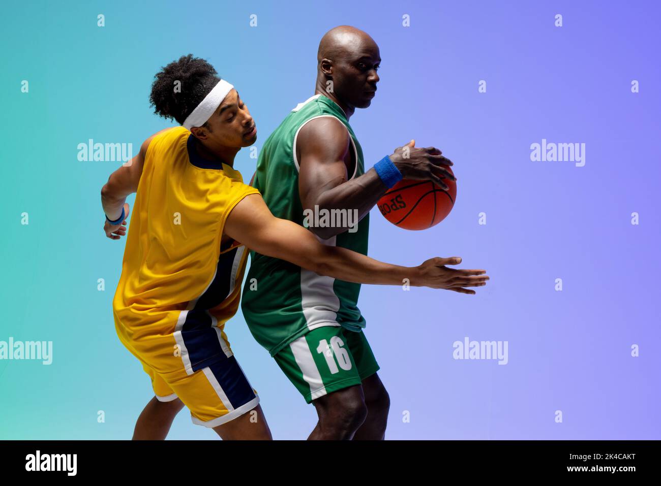 Image of two diverse basketball players with basketball playing on purple to green background. Sports and competition concept. Stock Photo