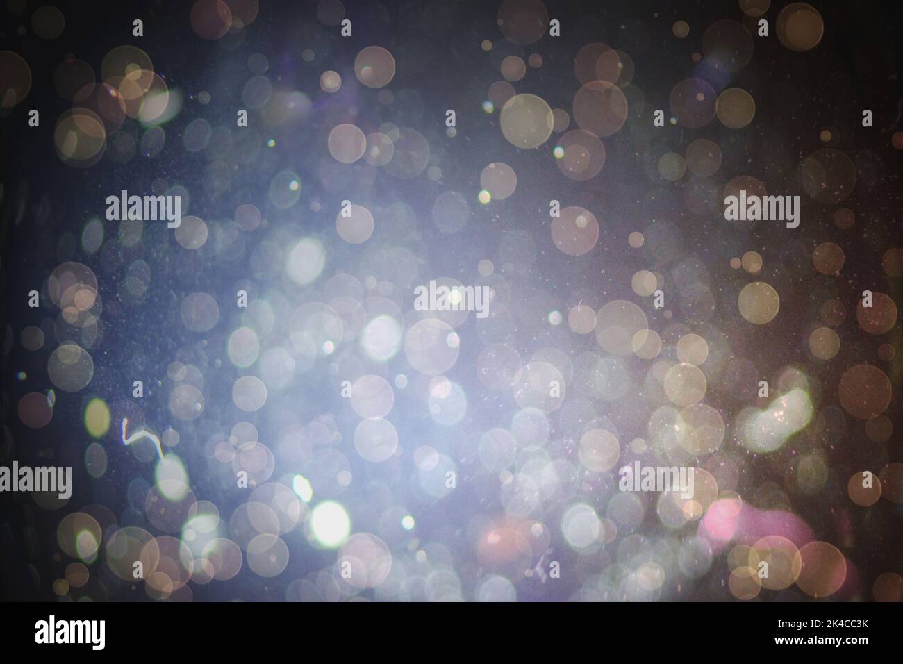 Abstract illustration of bokeh spots of light against black background ...