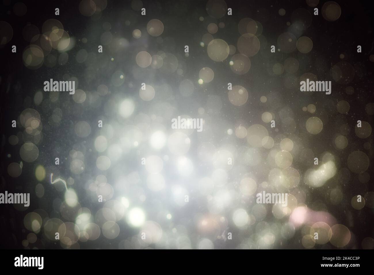 Abstract illustration of bokeh spots of light against black background ...
