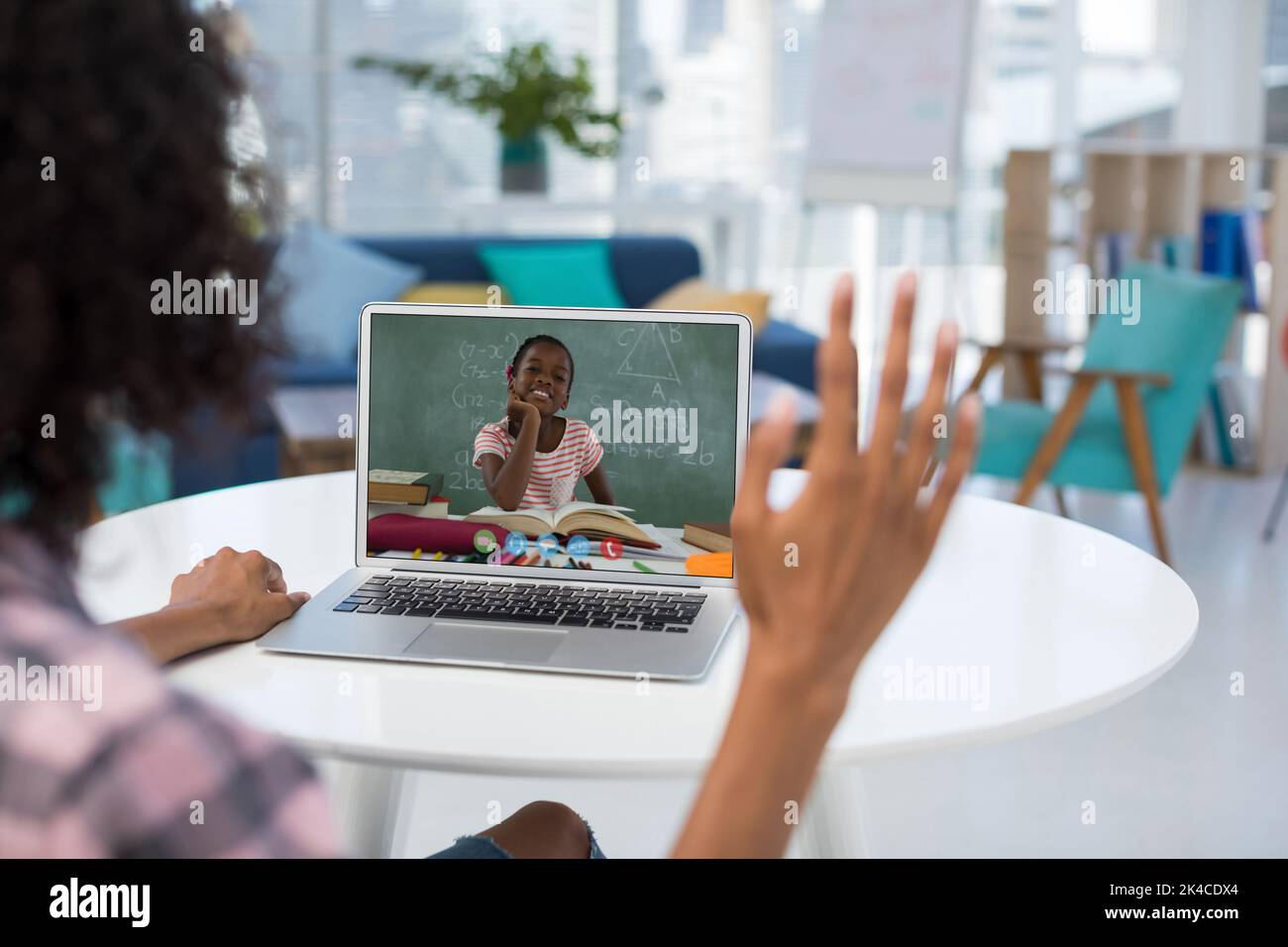 Female teacher having a video call with female student on laptop at ...