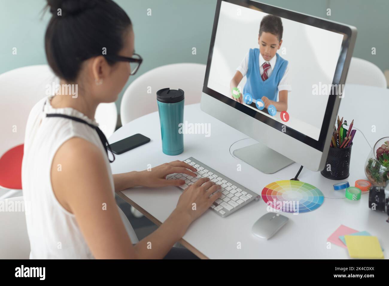 Female teacher having a video call with male student on computer at ...