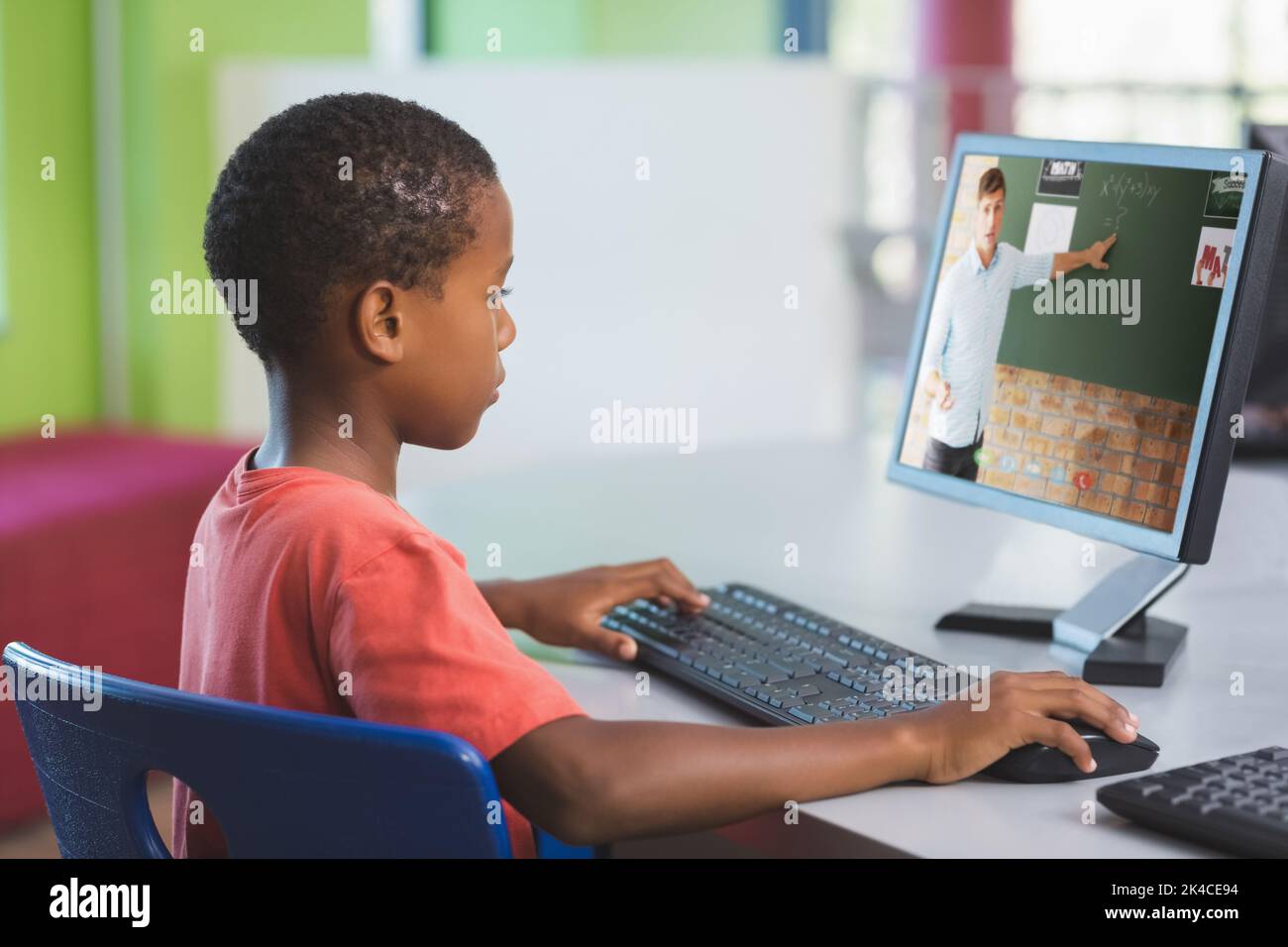 African american schoolboy using computer on video call with male ...