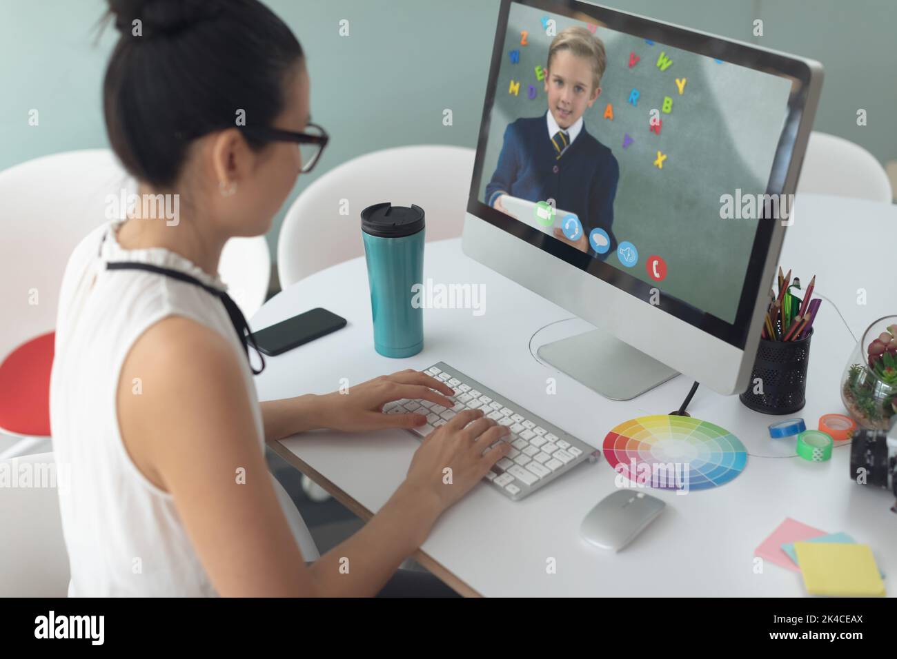 Female teacher having a video call with male student on computer at ...