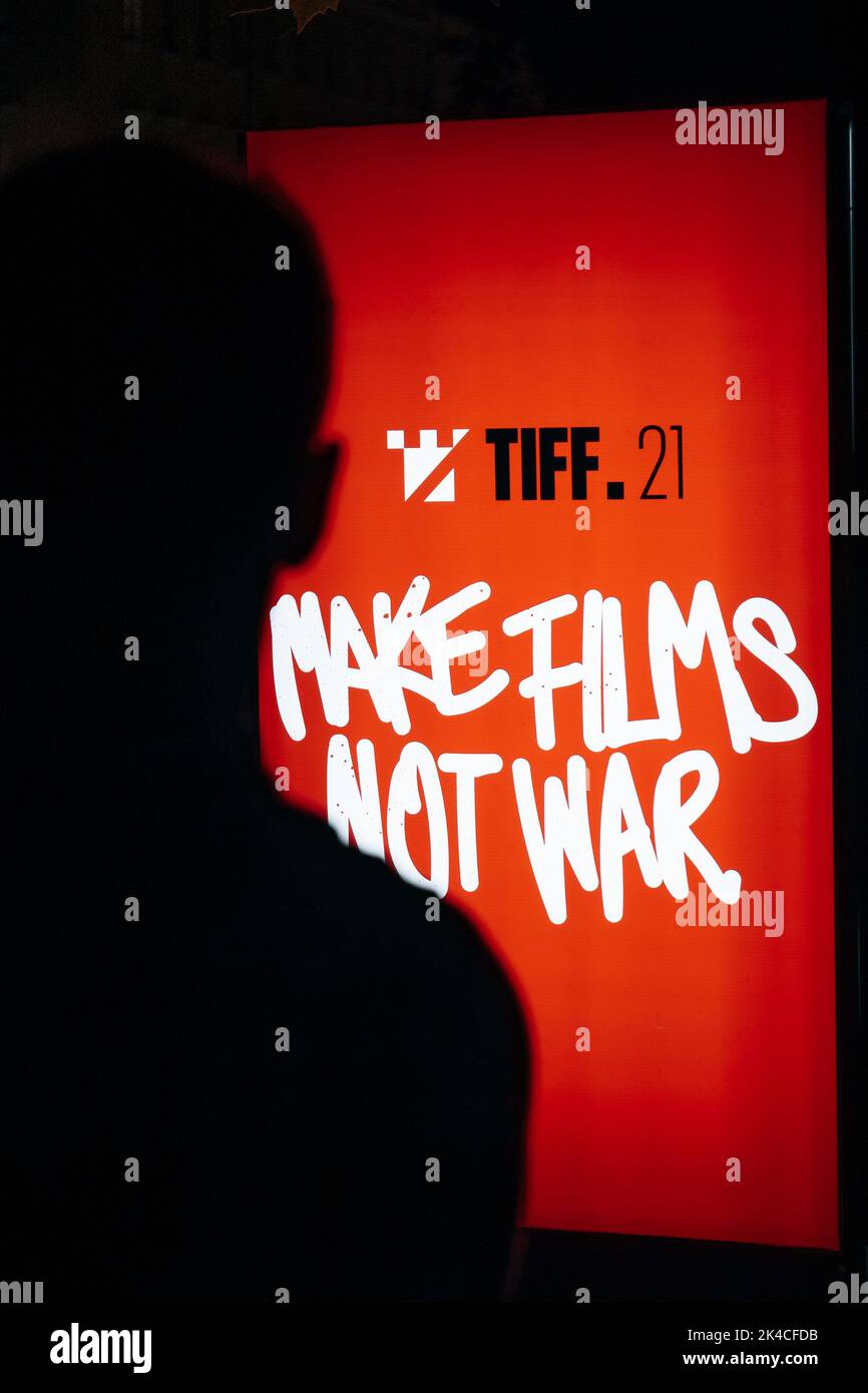 A vertical shot of the Transilvania International Film Festival banner 'Make films not war' with a male silhouette Stock Photo