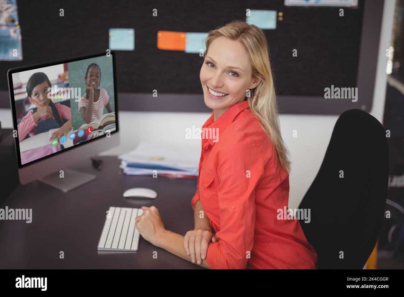 Portrait of female teacher having a video conference with two female ...