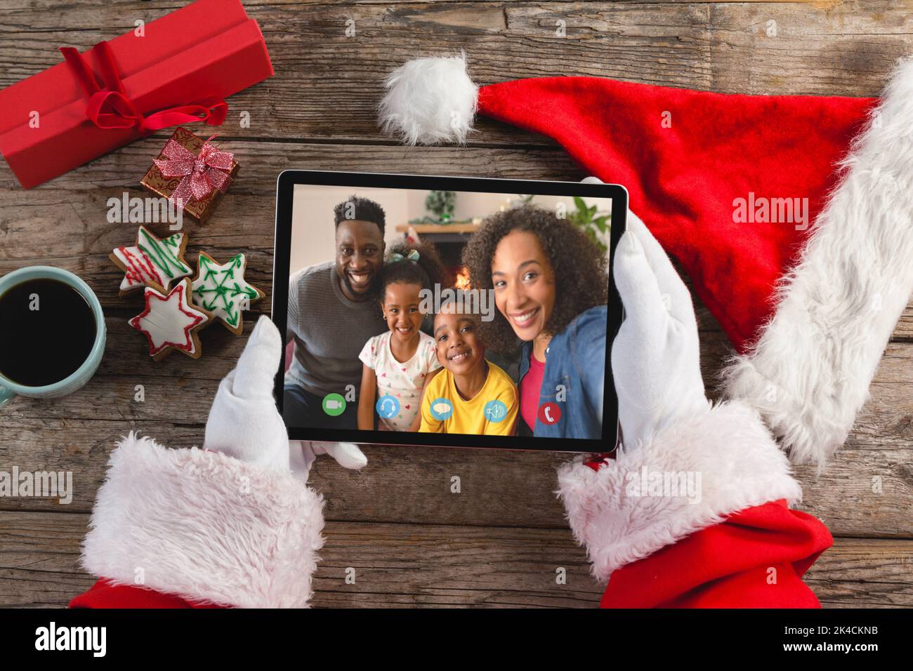 Santa claus making tablet christmas video call with smiling african