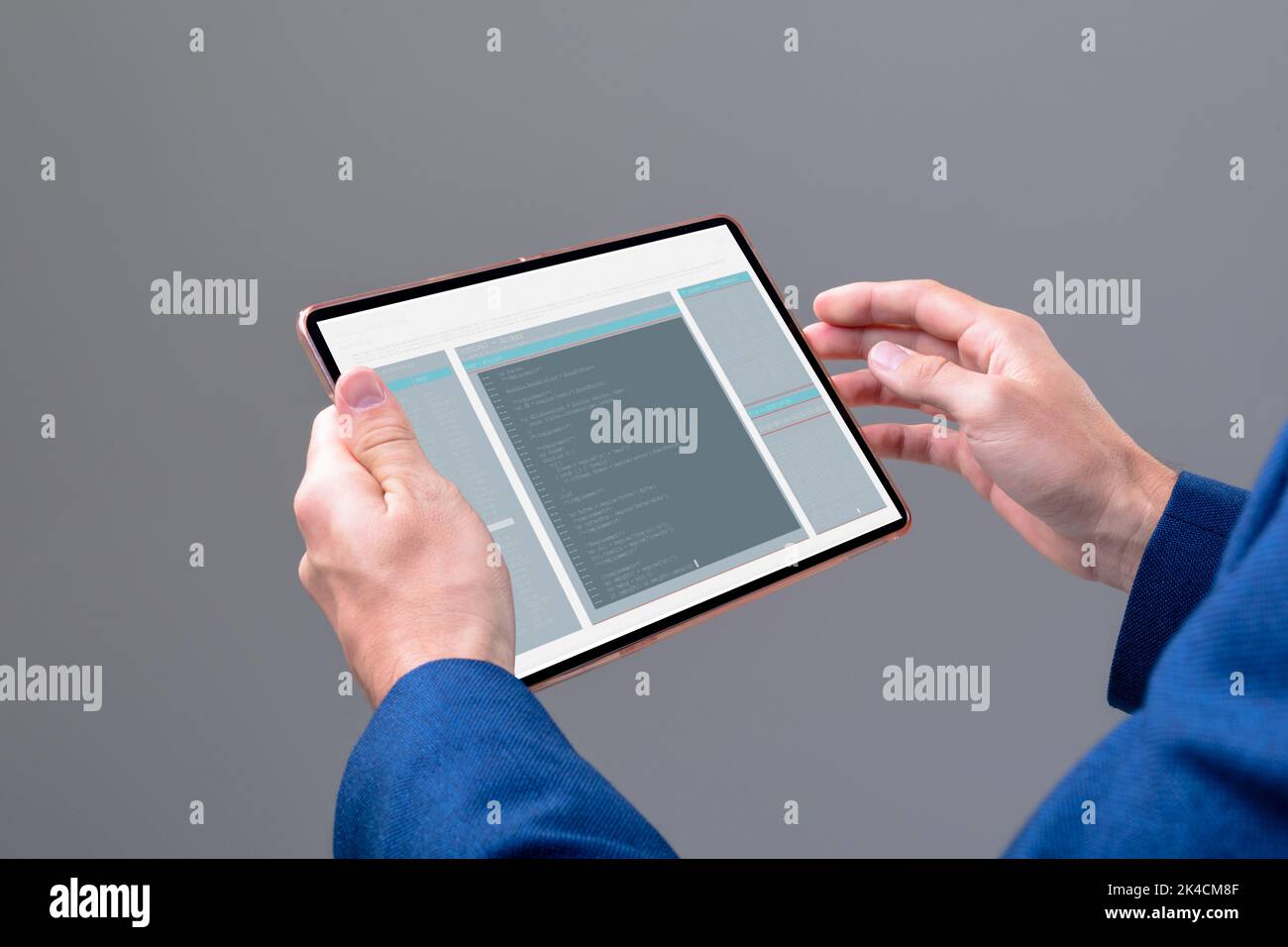 Hands of caucasian male programmer using tablet with coding on screen. coding, programming and computer technology digital composite image. Stock Photo