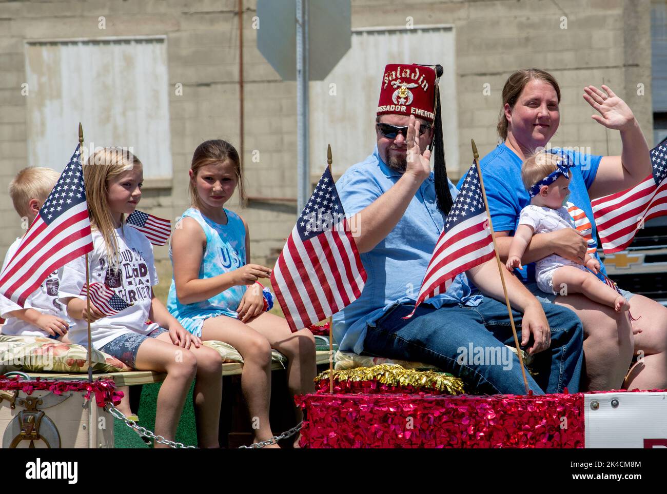 Eau Claire MI USA July 4 2022; A man wearing a Shriners hat, rides on a