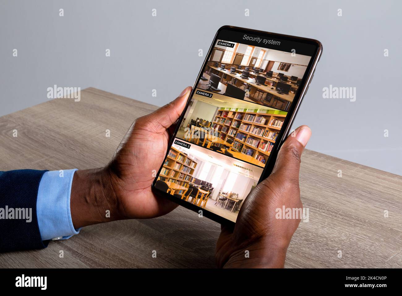 Hands of african american man holding tablet with view of library from ...