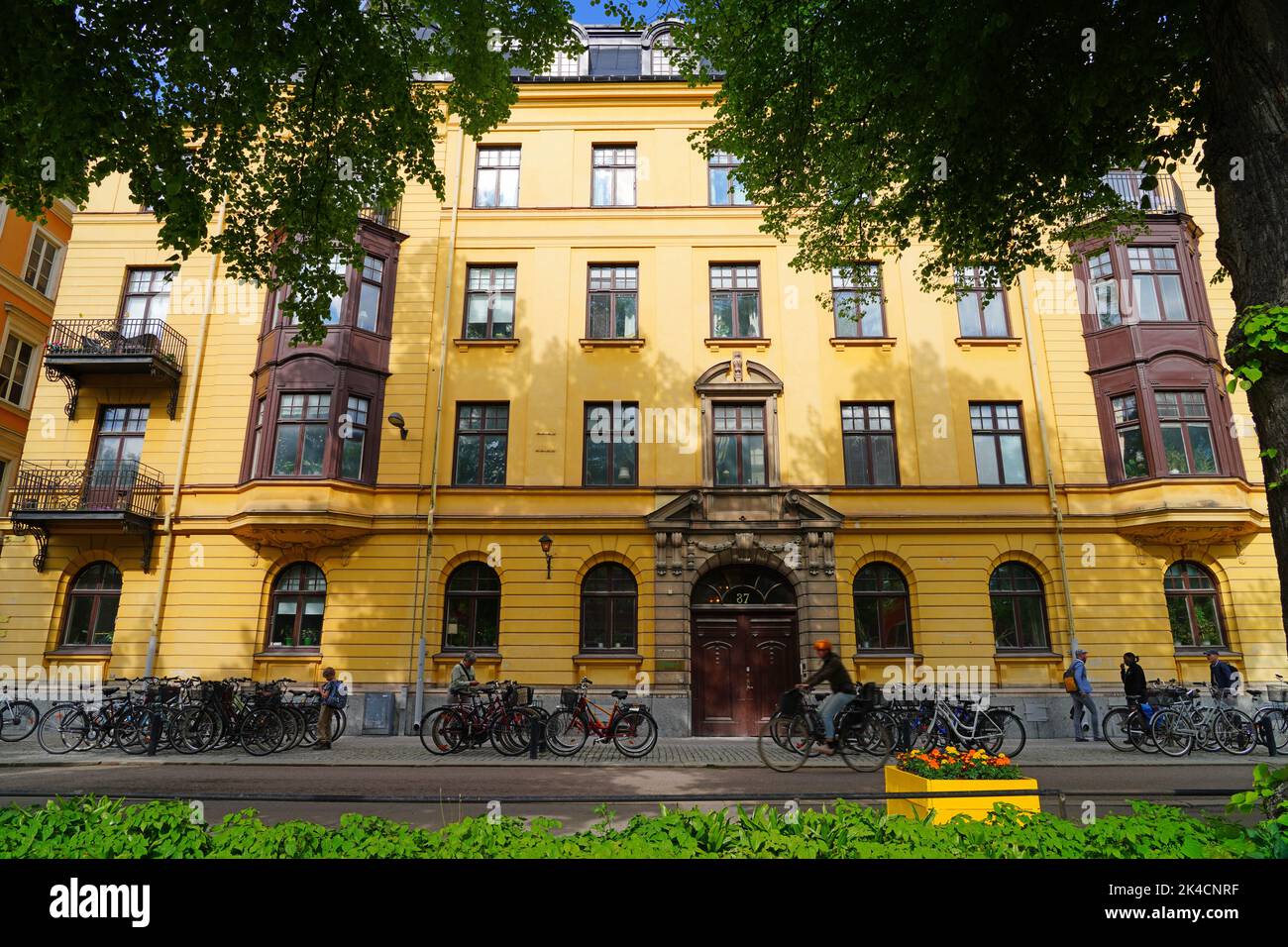 UPPSALA, SWEDEN -1 JUN 2022- View of buildings on the street in downtown Uppsala, a university town in Sweden, on the Fyrisan river. Stock Photo