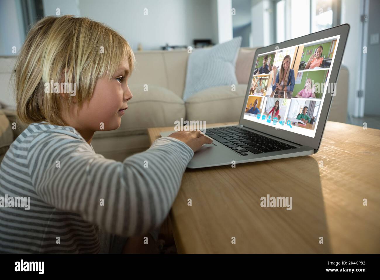 Smiling caucasian boy using laptop for video call, with diverse ...