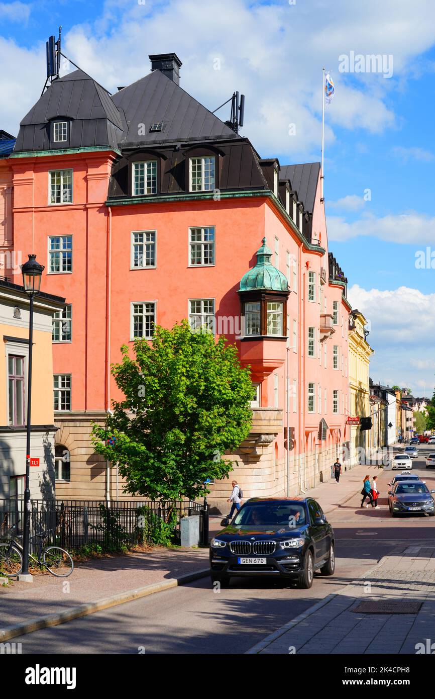 UPPSALA, SWEDEN -1 JUN 2022- View of buildings on the street in downtown Uppsala, a university town in Sweden, on the Fyrisan river. Stock Photo